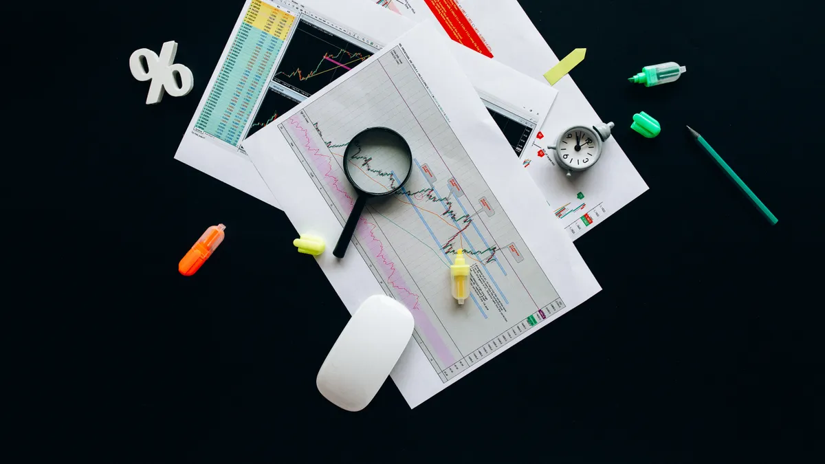 documents and charts being reviewed on a desk