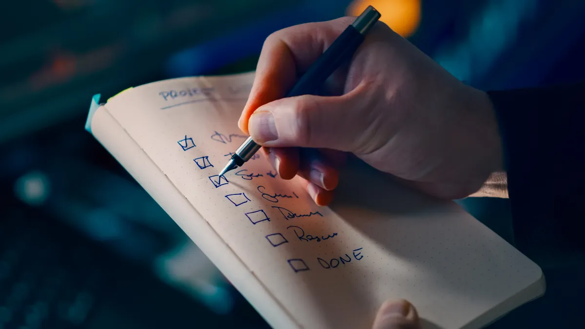Hand checking items on a written checklist