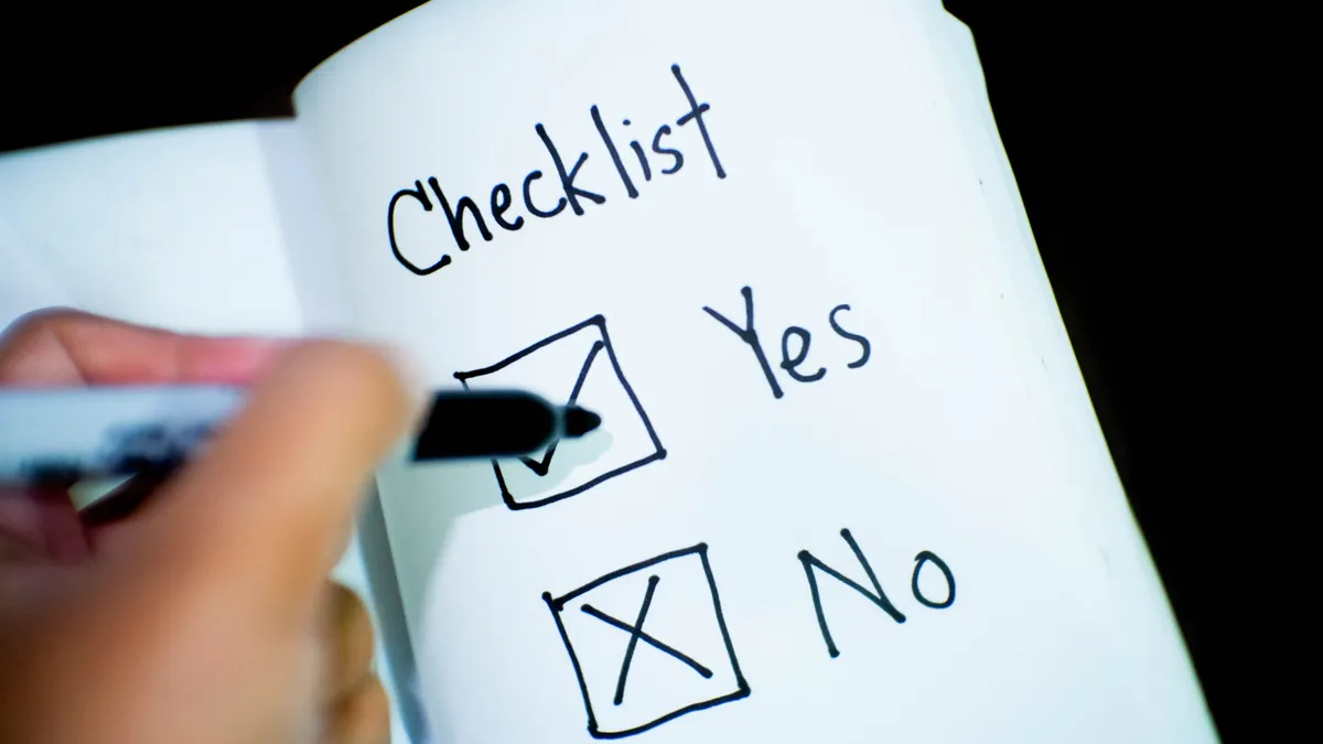 Checklist with yes/no boxes being marked