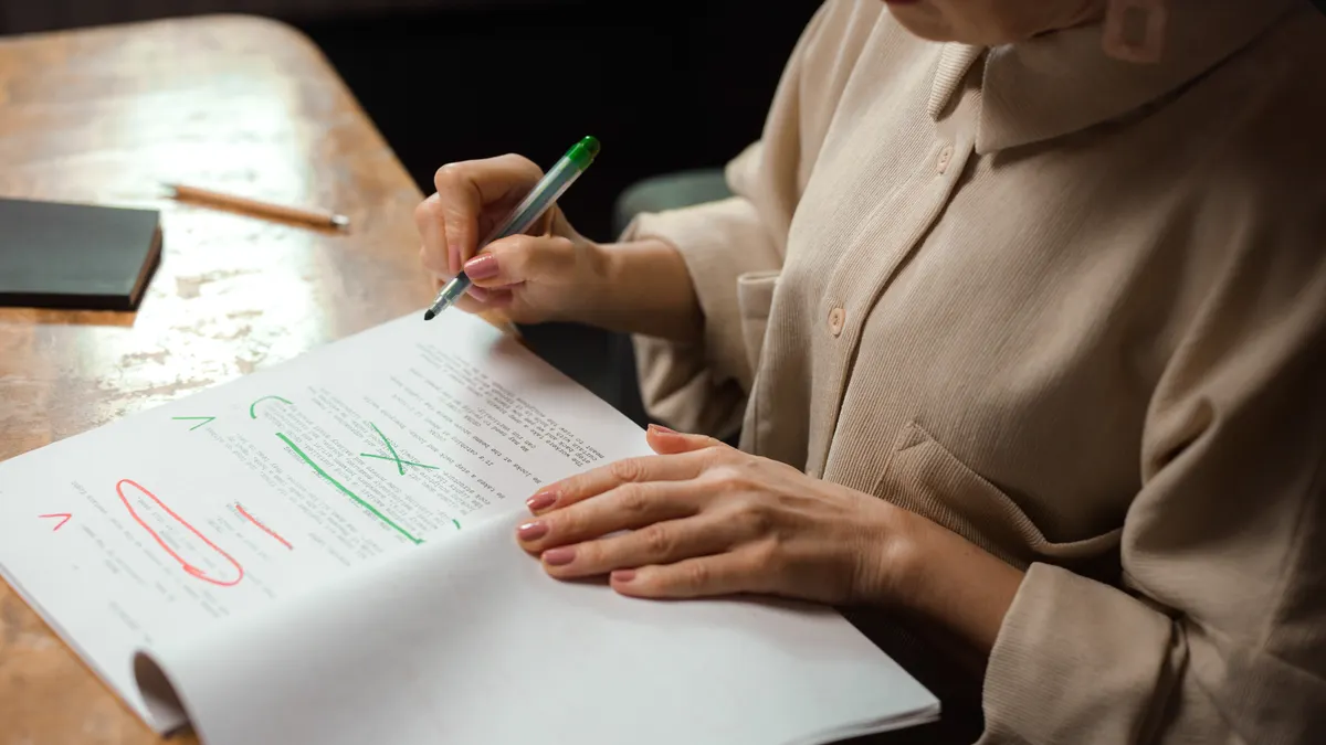 person marking up a document with corrections