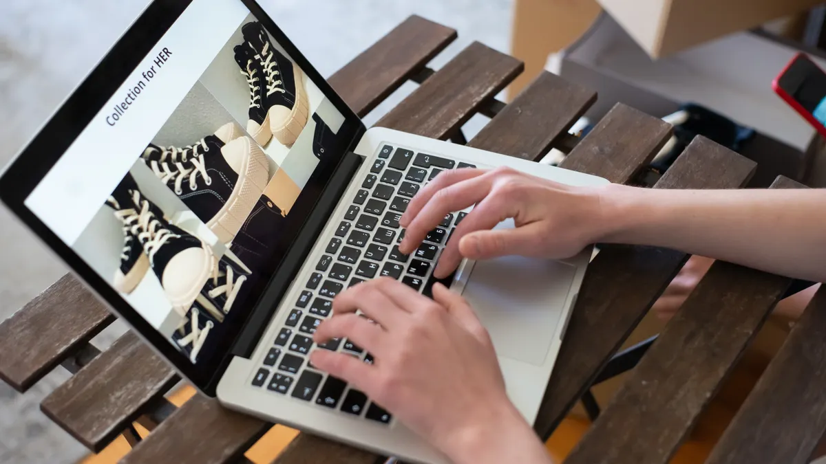 hands using laptop on a product listing page