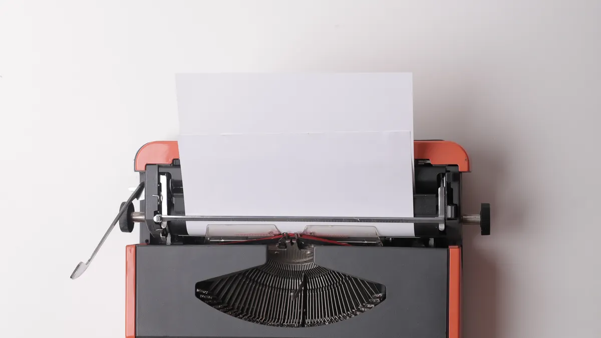 Anyword review for ad copy and landing pages — Writer working on typewriter in office
