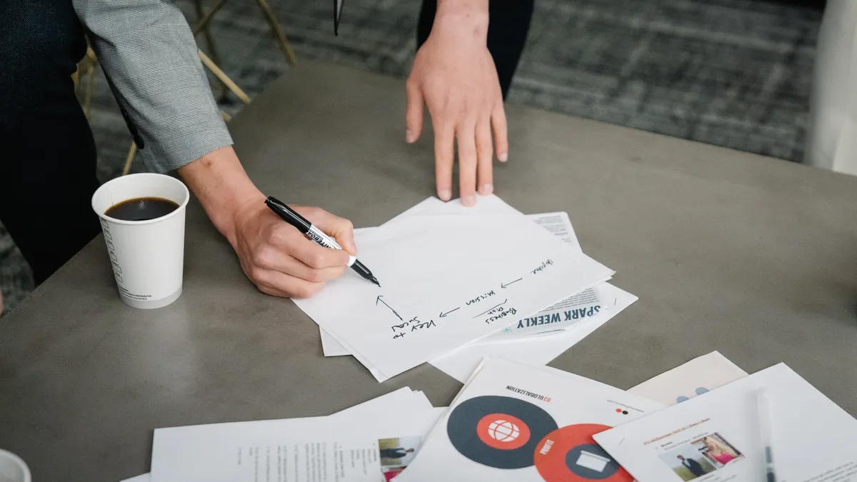 Copy.ai review for copywriting teams — Person writing on White Paper
