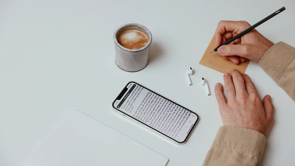 Jasper AI review for bloggers — Person Writing a Note on White Table