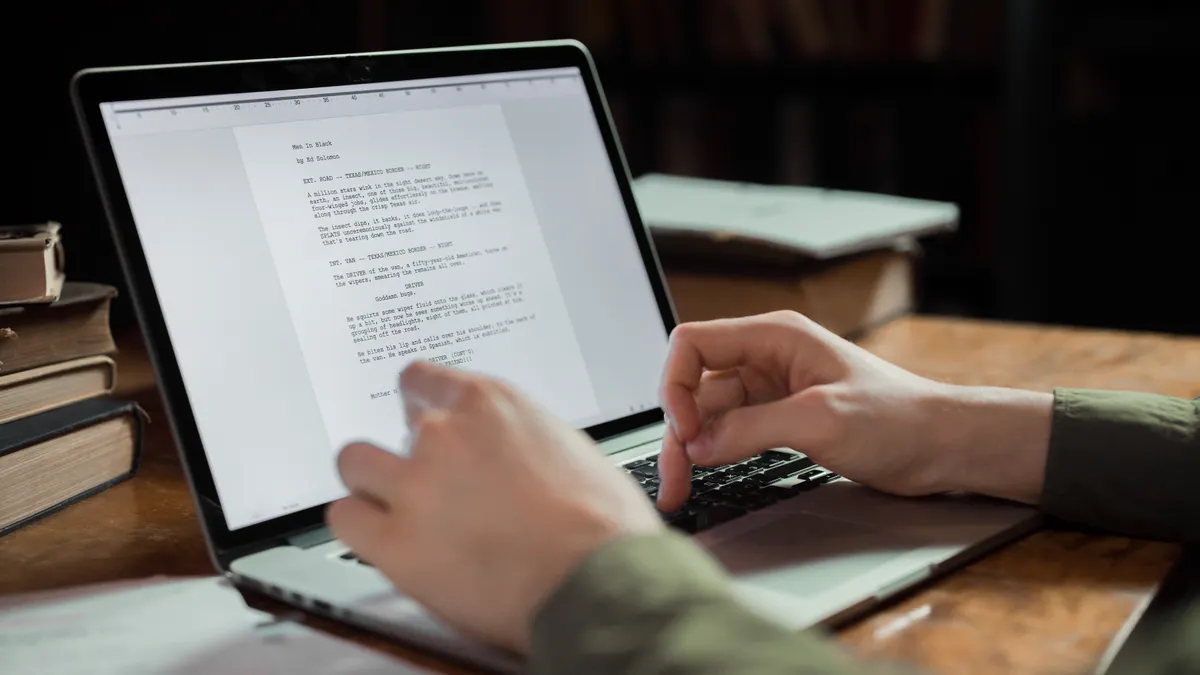 person editing text on a laptop
